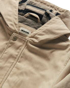 material shot of the hood and button closure of The Workhorse Hoodie in Sand Boss Duck, Outerwear by Taylor Stitch