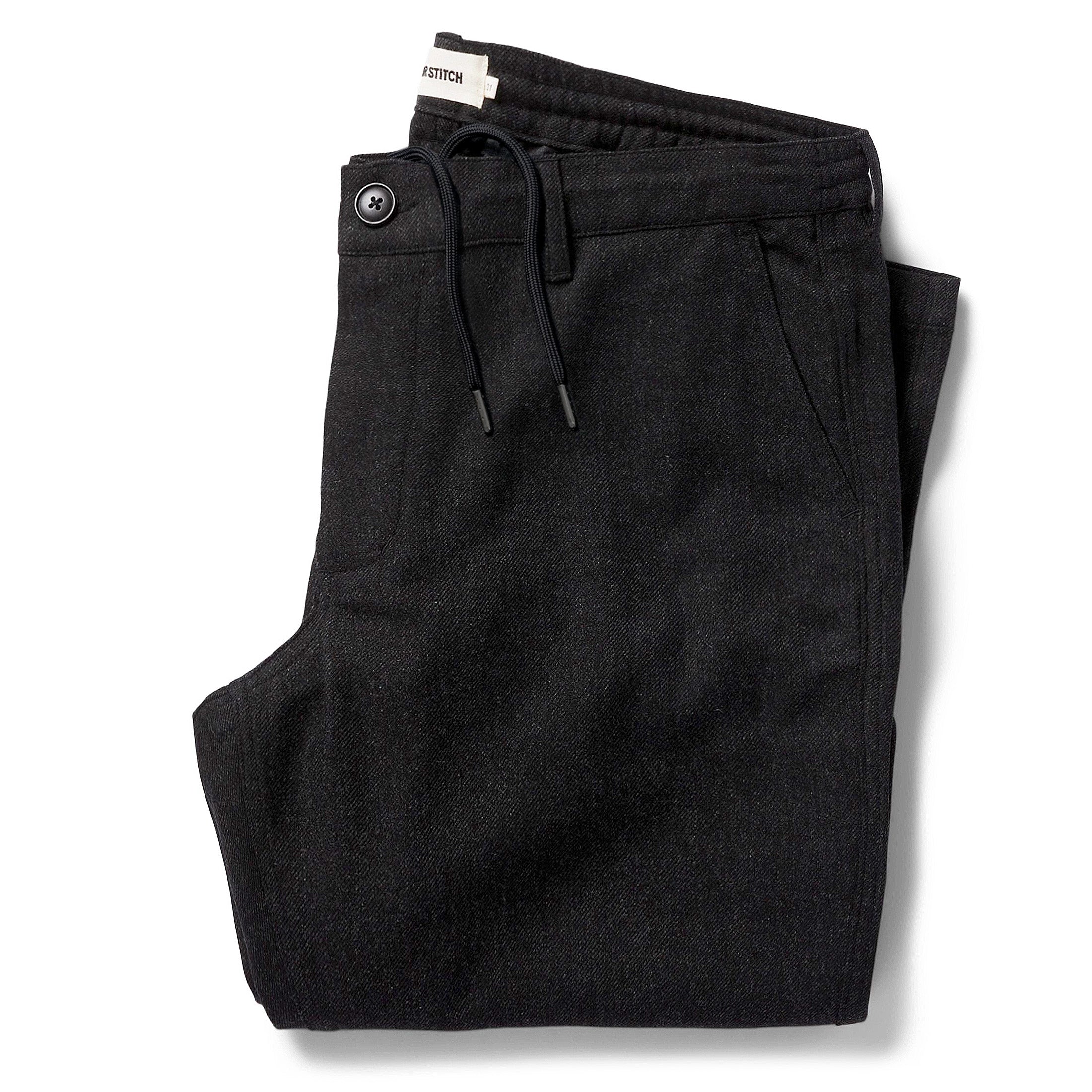 flatlay of The Carmel Pant in Dark Charcoal folded, Bottoms by Taylor Stitch