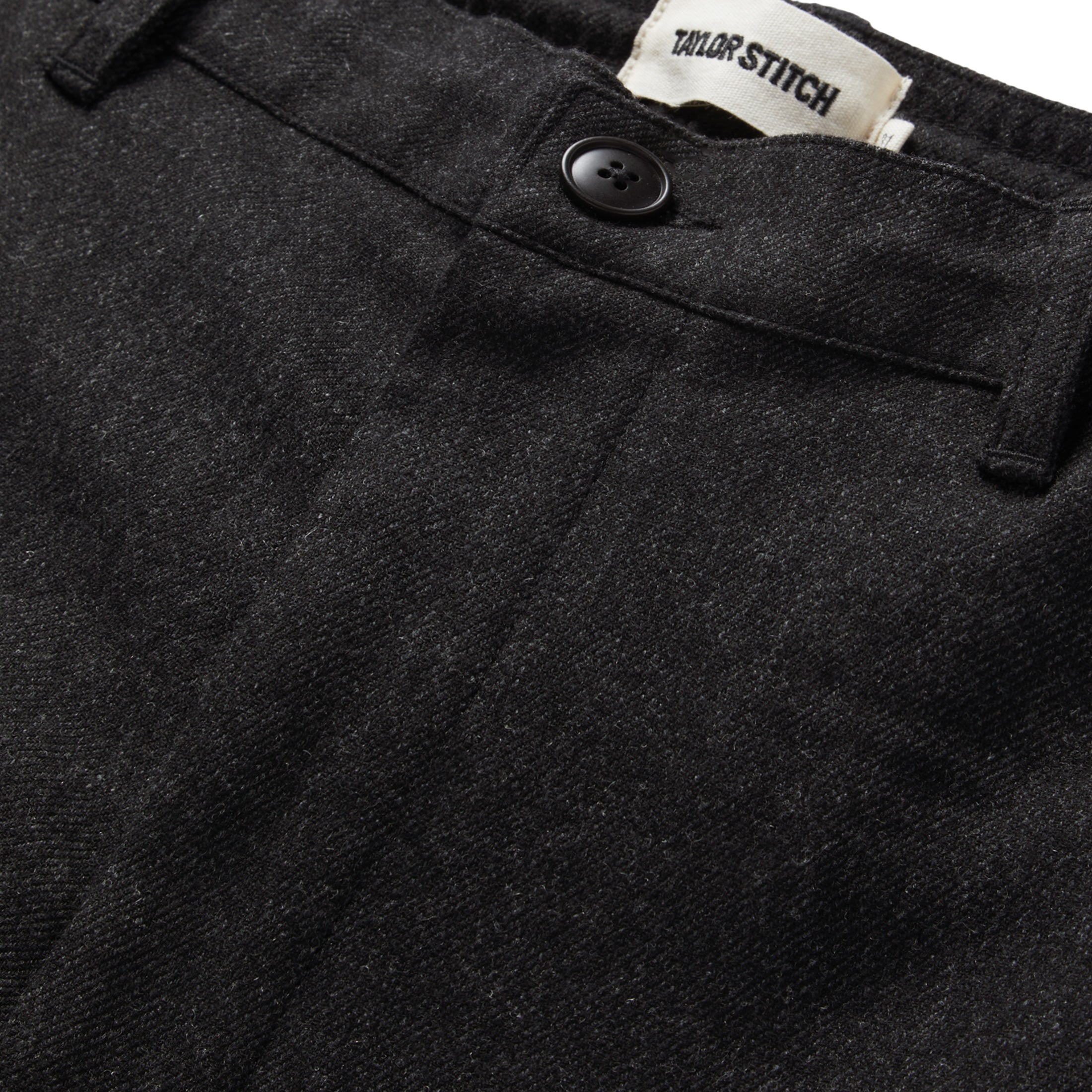 material shot the button fly of The Carmel Pant in Dark Charcoal, Bottoms by Taylor Stitch