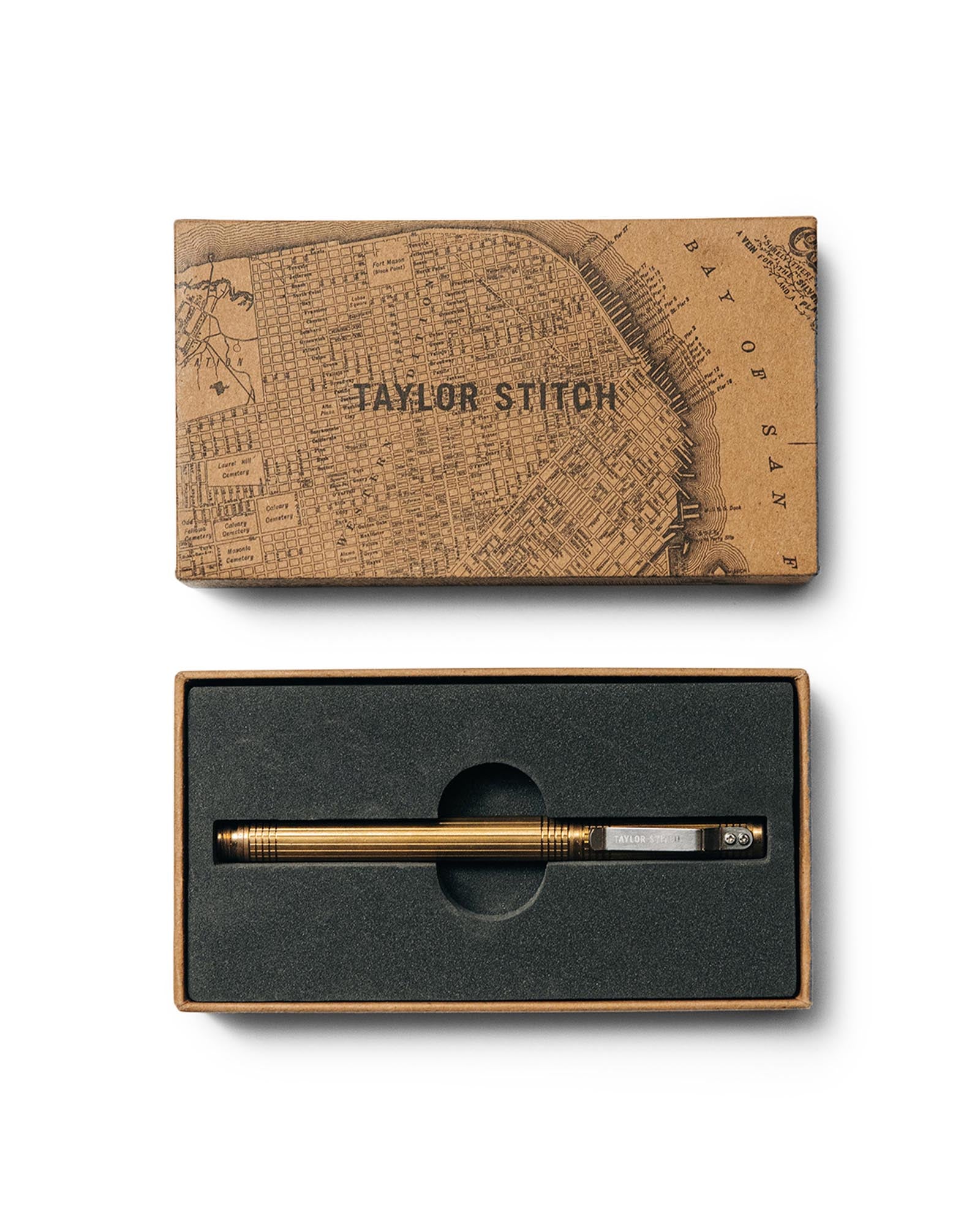 flatlay of The Pen in Brass in a Taylor Stitch gift box