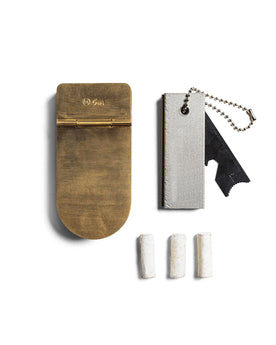 editorial image of The Tinder Box in Brass shown next to other products, Accessories by Taylor Stitch