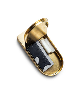 editorial image of The Tinder Box in Brass opened with products inside, Accessories by Taylor Stitch