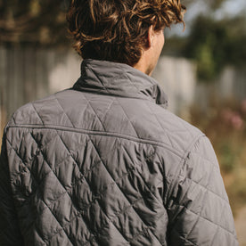 The fit model showing us the back of the vertical jacket in ash