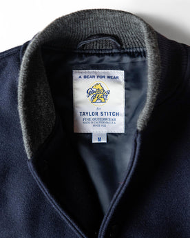 material shot of the Golden Bear label on The Golden Bear Snap Bomber in Midnight Wool, Outerwear by Taylor Stitch