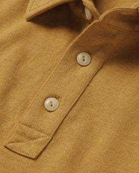 material shot of the buttons on The Heavy Bag Polo in Gold, Knits by Taylor Stitch