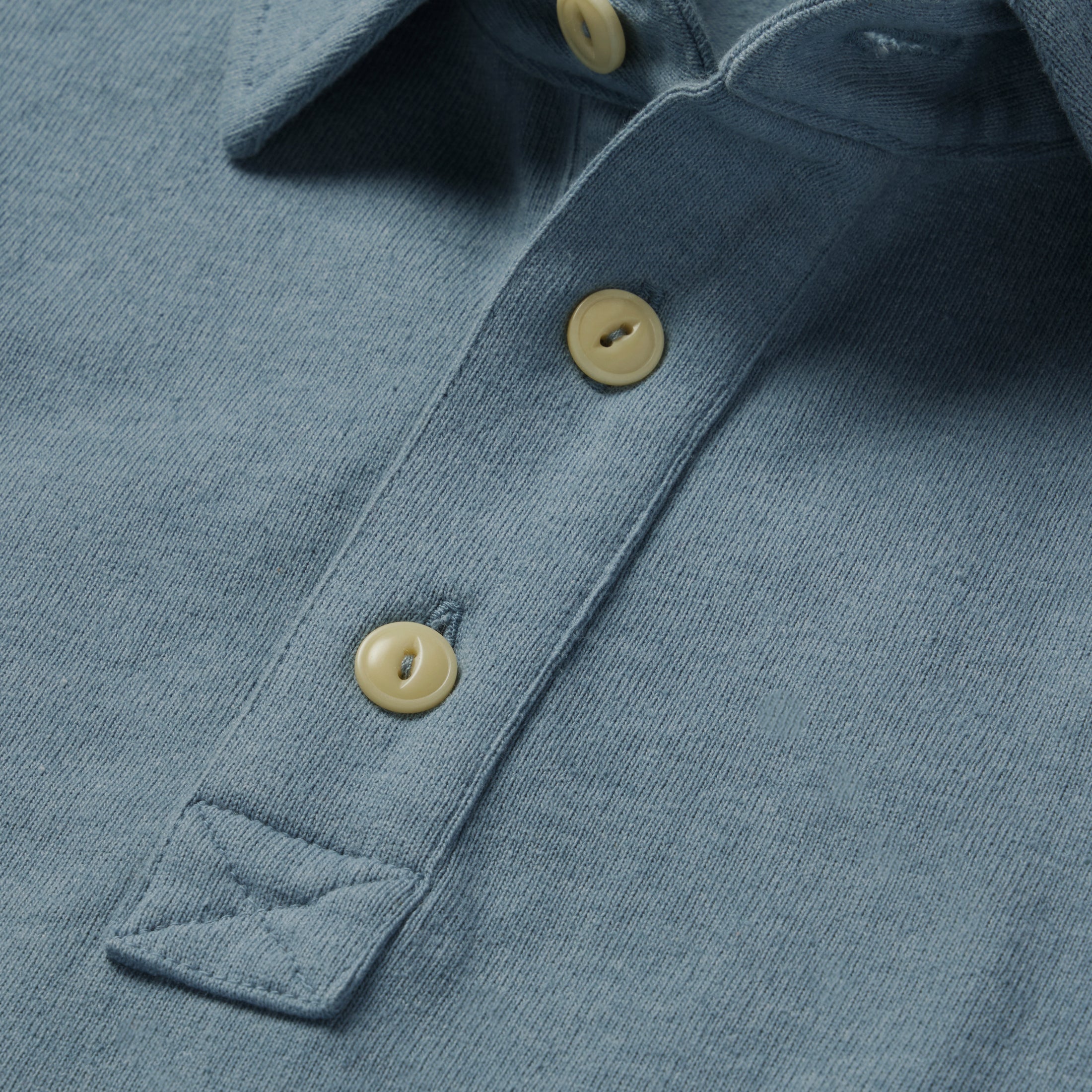 material shot of the buttons on The Heavy Bag Polo in Ocean, Knits by Taylor Stitch
