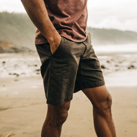 fit model posing on the beach in The Morse Short in Dark Charcoal Linen