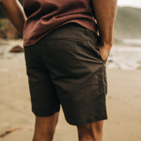 fit model wearing The Morse Short in Dark Charcoal Linen on the beach