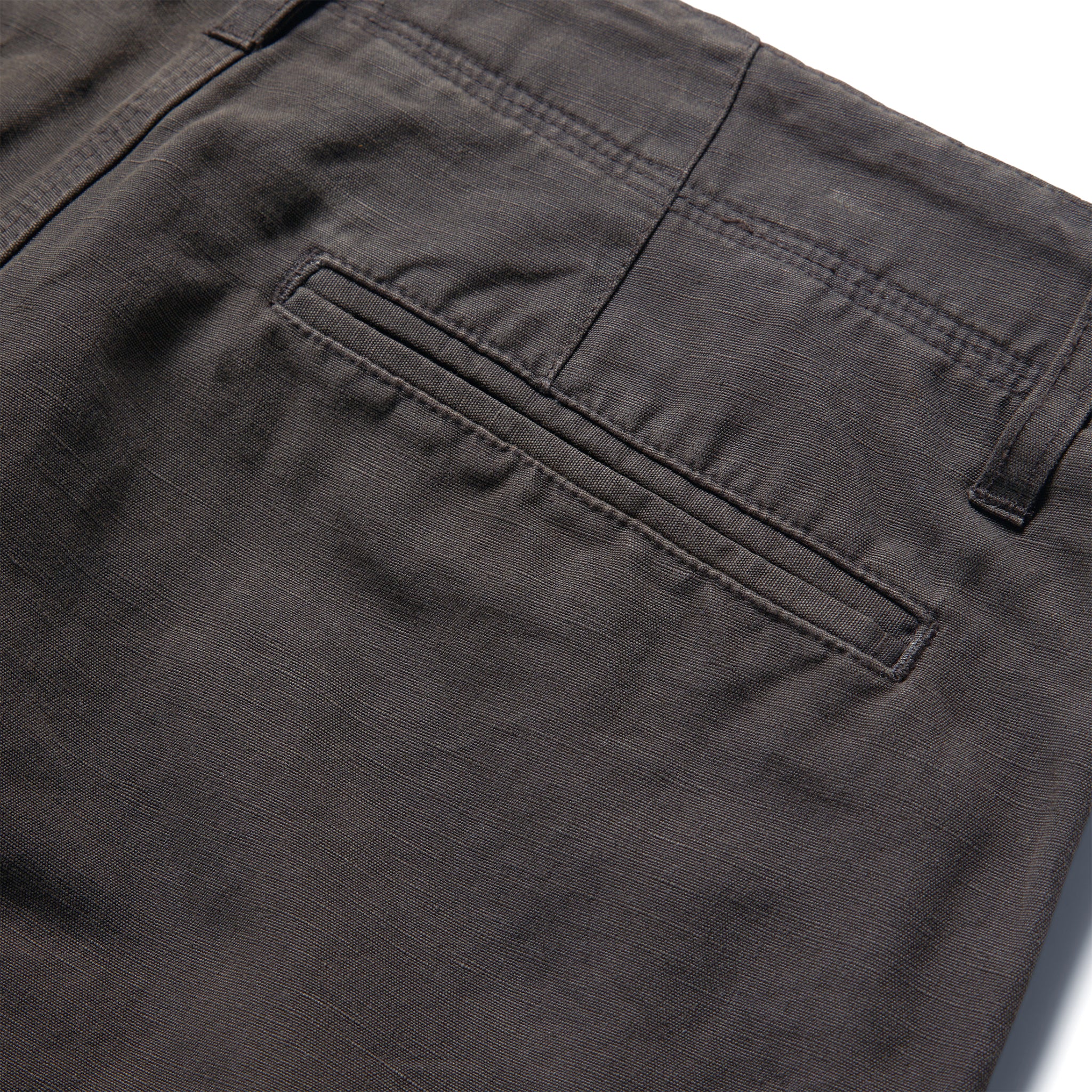 material shot of the rear pocket on The Morse Short in Dark Charcoal Linen, Shorts by Taylor Stitch