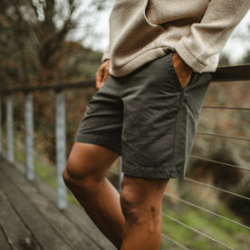 fit model leaning against a railing in The Morse Short in Dark Slate Linen