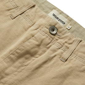 material shot of the button on The Morse Short in Sand Linen