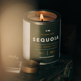 material shot of flatlay of The Camp Candle in Sequoia on a table