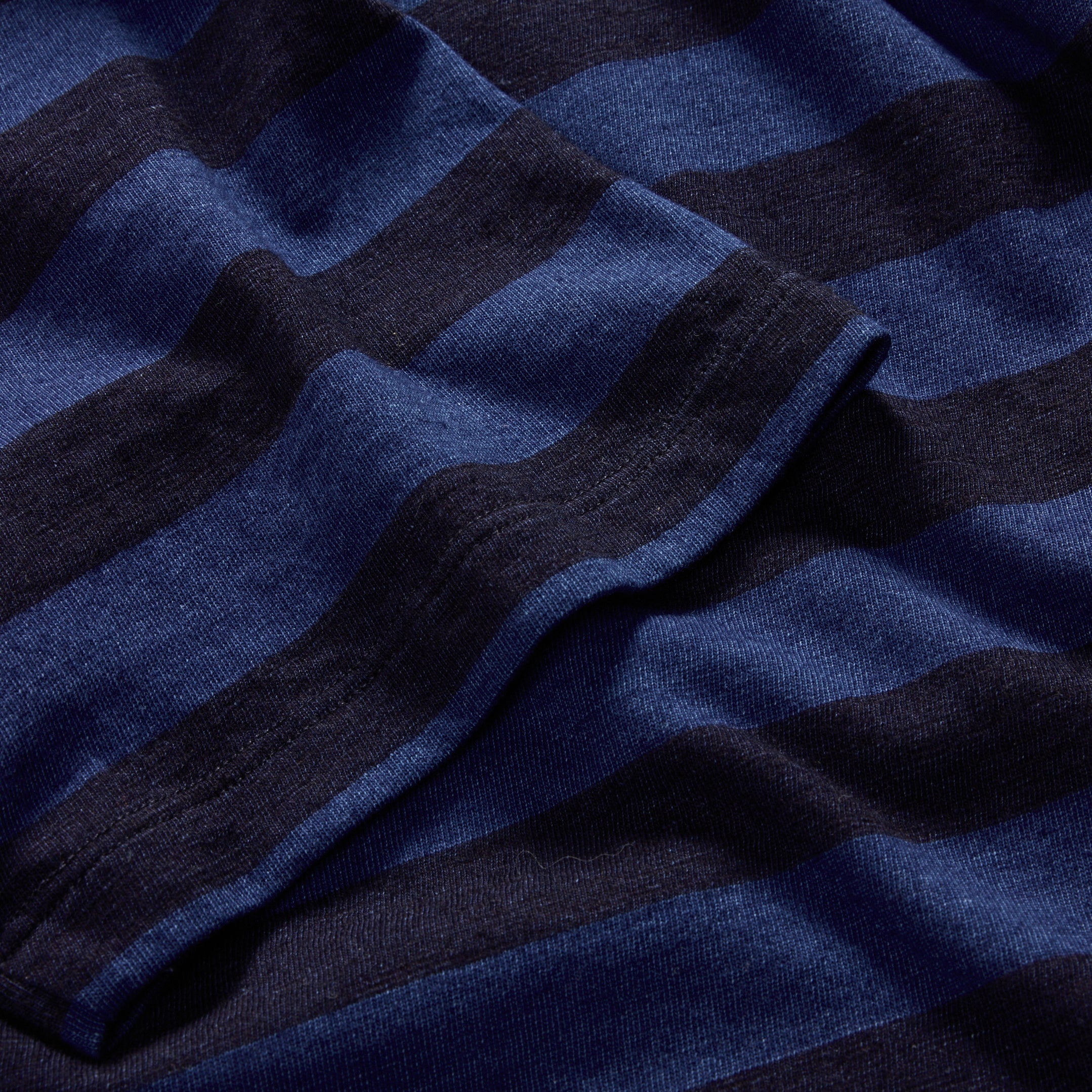material shot of the sleeve of The Organic Cotton Tee in Indigo Yarn Dye Stripe, Knits by Taylor Stitch