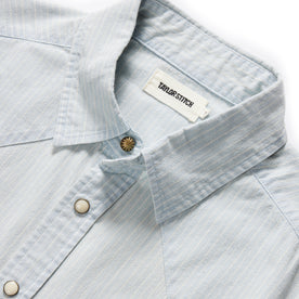 material shot of the brass button and collar on The Western Shirt in Bleached Indigo Stripe