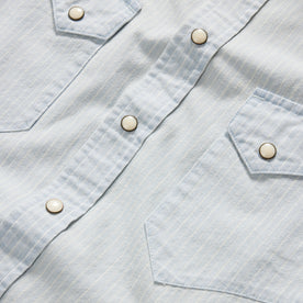 material shot of the buttons and dual chest pockets on The Western Shirt in Bleached Indigo Stripe
