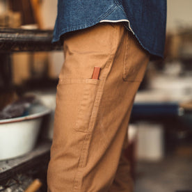 Fit model in the chore pants in washed camel