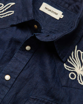 material shot of the collar and buttons on The Embroidered Short Sleeve Western in Indigo Linen, Wovens by Taylor Stitch