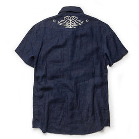flatlay of The Embroidered Short Sleeve Western in Indigo Linen, from the back