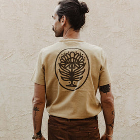 fit model facing the back in The Heavy Bag Tee in Khaki Dahlia