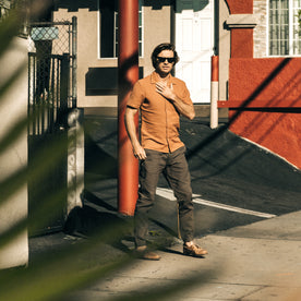 fit model walking on a sunny street in The Apres Pant in Walnut Double Cloth
