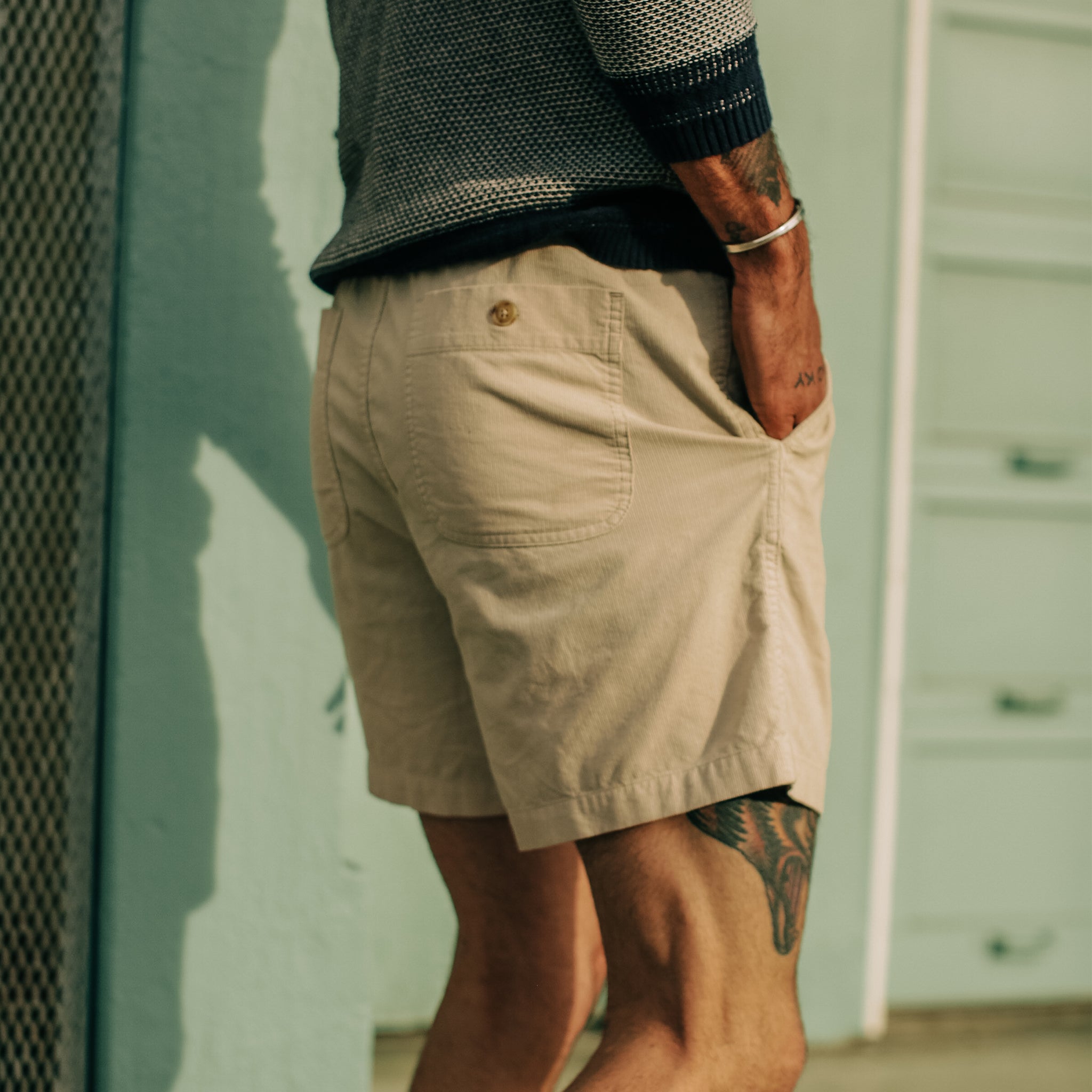model posing with his hand in the pocket of The Après Short in Natural Pinwale, Shorts by Taylor Stitch
