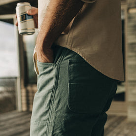 fit model wearing The Chore Pant in Ocean Boss Duck while holding a beer
