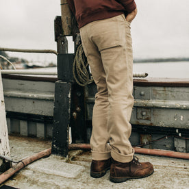 fit model standing by the edge of a boat in The Chore Pant in Sand Boss Duck