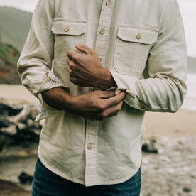 fit model wearing The Division Shirt in Natural Selvage while adjusting his shirt cuffs