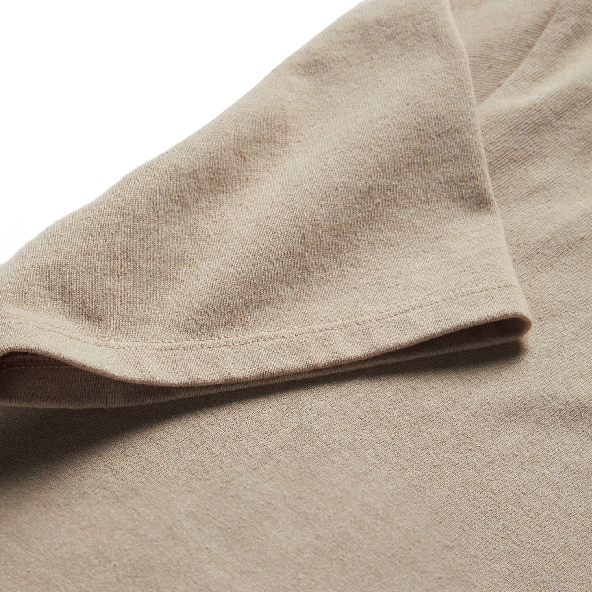 material shot of the sleeves on The Short Sleeve Heavy Bag Henley in Sand, Knits by Taylor Stitch