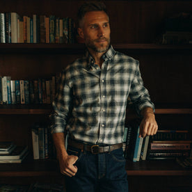 fit model next to bookshelf in The Jack in Navy Plaid