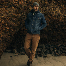 fit model walking along the shore in The Long Haul Jacket in Sawyer Wash Organic Selvage