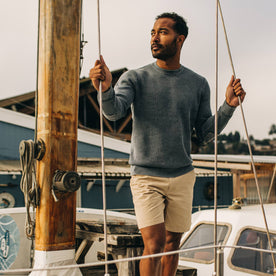 fit model on a boat in The Moor Sweater in Washed Indigo