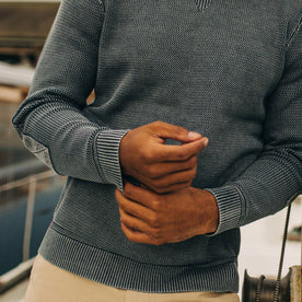 fit model showing sleeve cuffs of The Moor Sweater in Washed Indigo