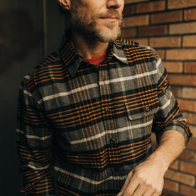 fit model showing the front of The Moto Shirt in Orange Plaid