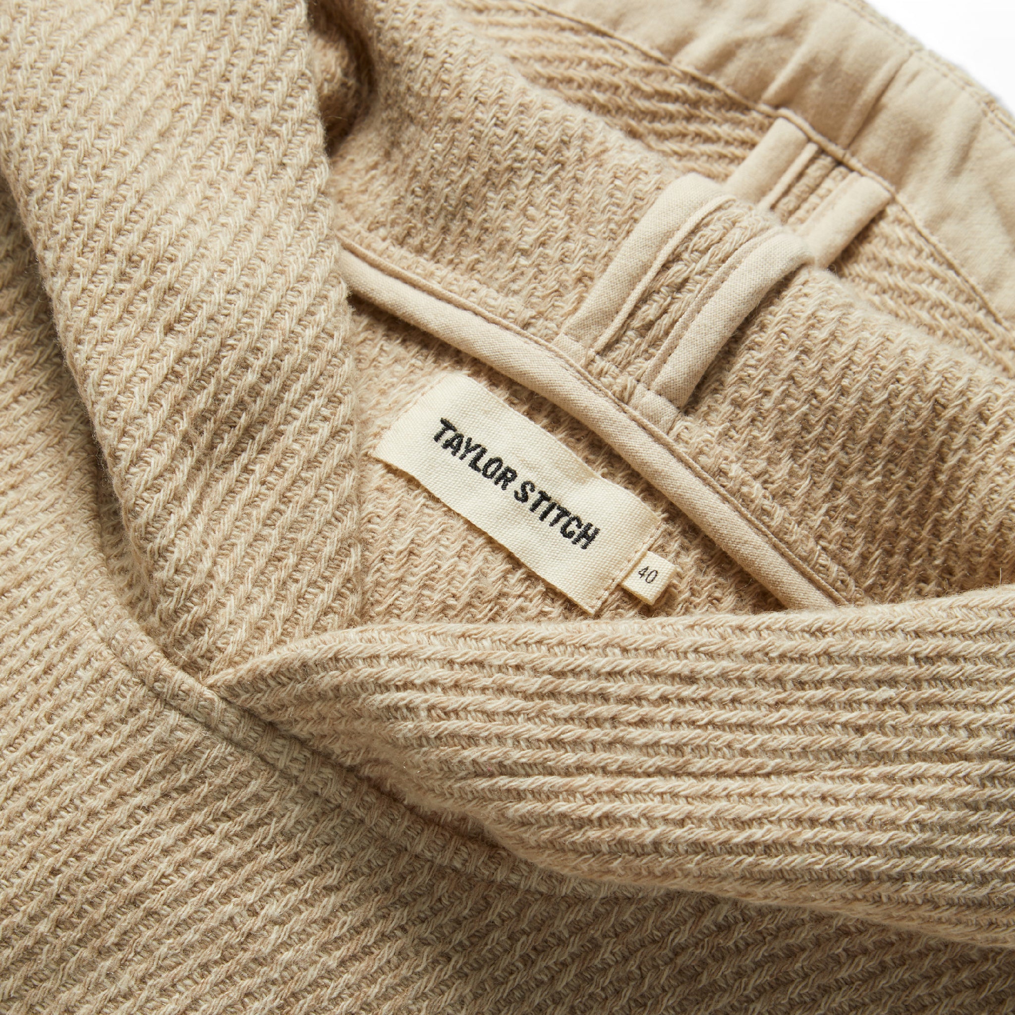 material shot of the label on The Nomad Hoodie in Flax Twill, Knits by Taylor Stitch