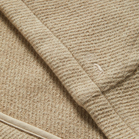 material shot of the Taylor Stitch logo on The Nomad Hoodie in Flax Twill