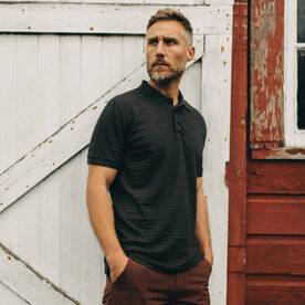 fit model with hands in pocket with The Polo in Dark Charcoal Jacquard