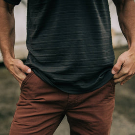 fit model adjusting hem of The Polo in Dark Charcoal Jacquard