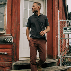 fit model walking down steps in The Polo in Dark Charcoal Jacquard
