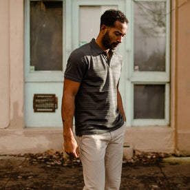 fit model wearing The Polo in Dark Slate Jacquard in front of a store front