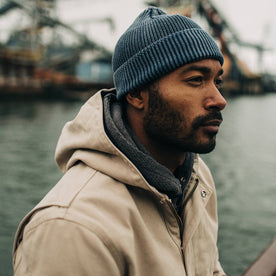 fit model on a boat in The Rib Beanie in Washed Indigo