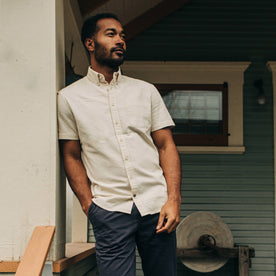 fit model wearing The Short Sleeve Jack in Natural Seersucker on a porch