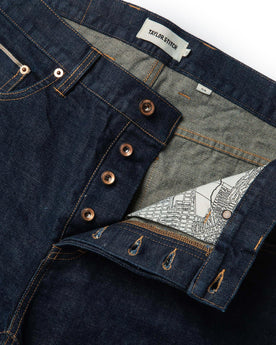 material shot of open front placket of The Slim Jean in Rinsed Organic Selvage, Bottoms by Taylor Stitch