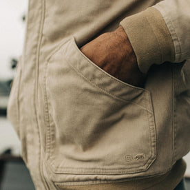 fit model with his hands in the pockets of The Workhorse Hoodie in Sand Boss Duck