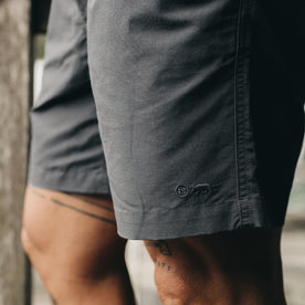 fit model showing the TS logo on The Apres Short in Granite Sixty Forty