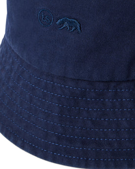 material shot of the logo on The Bucket Hat in Washed Navy Twill, Accessories by Taylor Stitch
