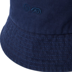 material shot of the logo on The Bucket Hat in Washed Navy Twill