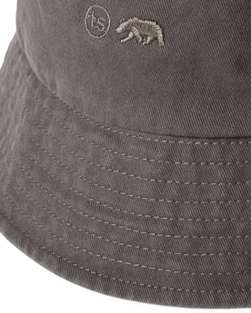 material shot of the logo on The Bucket Hat in Washed Taupe Twill, Accessories by Taylor Stitch