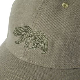 material shot of the logo on The Canvas Cap in Olive Embroidered Bear
