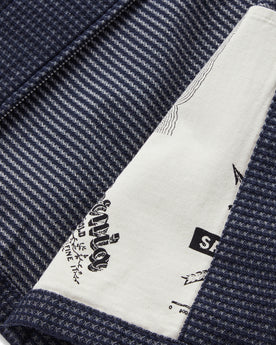material shot of the interior map print detail on  The Cavern Jacket in Navy Dobby Grid, Outerwear by Taylor Stitch